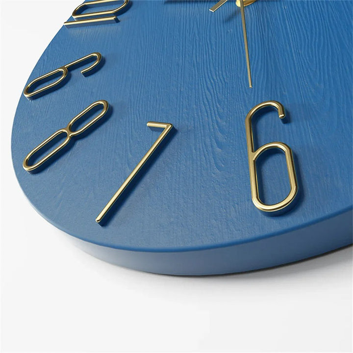 Close-up of the Modern Blue wall clock with gold numbers on a white background