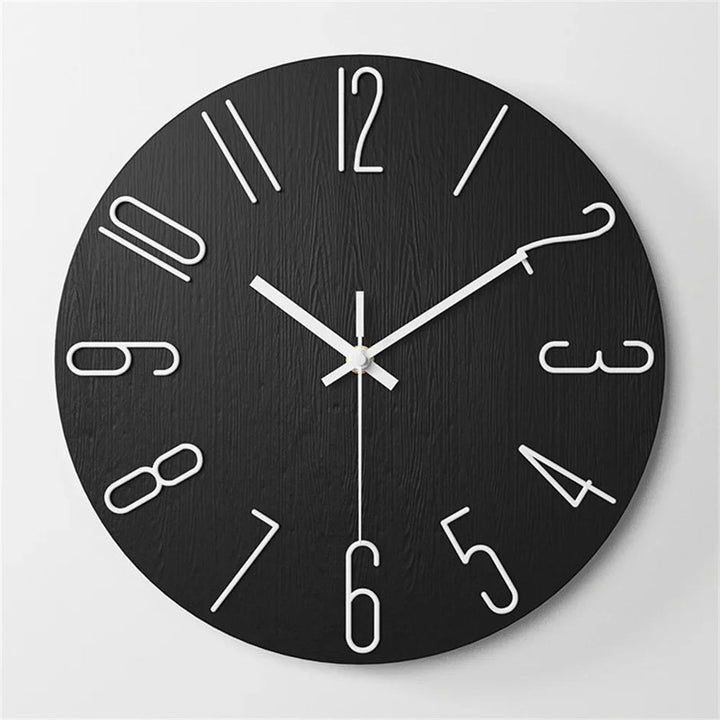 Black wall clock with white numbers and hands on a light gray background
