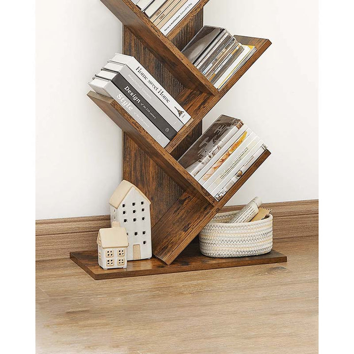 Wooden zigzag shelf with books and decorative items on a wooden surface.
