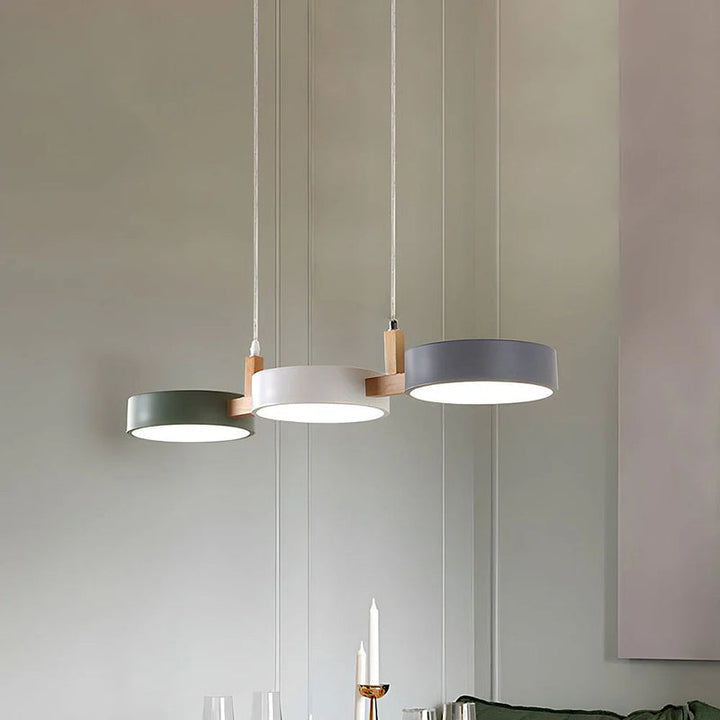 Modern kitchen island lighting featuring ALVA Nordic cylinder pendant light in muted tones.