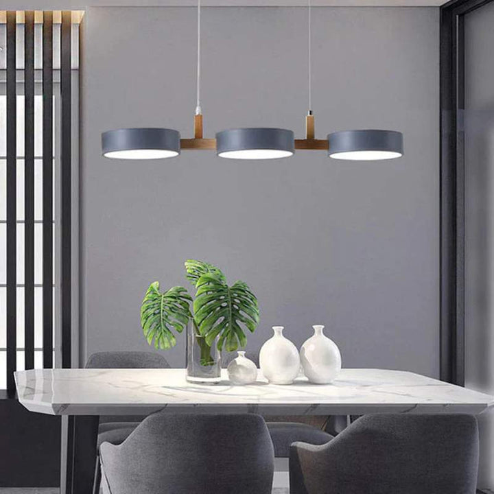 Elegant dining area illuminated by ALVA Nordic cylinder pendant light in Scandinavian style.