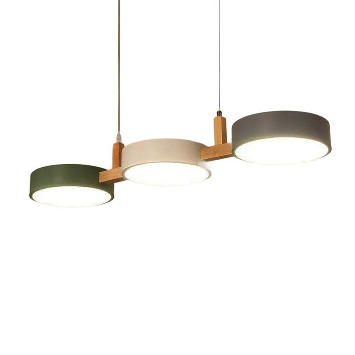 Modern pendant light with three circular shades on a white background