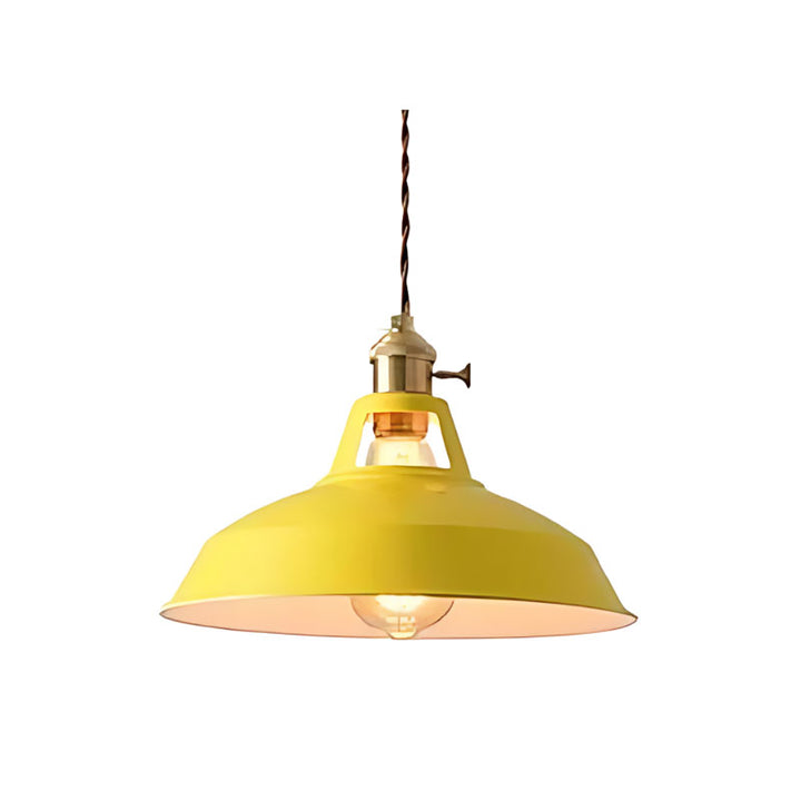 Yellow pendant light with brass fixture on a white background