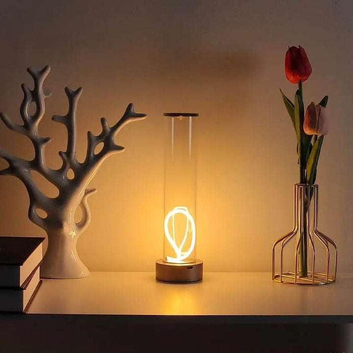 LYS Nordic magnetic LED desk lamp with cylindrical glass body, warm spiral light, USB rechargeable, on white shelf with décor