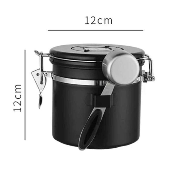 Small black stainless steel airtight coffee container with metal clamp and scoop, 12 cm × 12 cm.