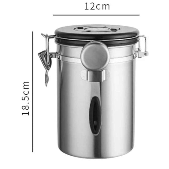 Silver stainless steel airtight coffee container with black lid and scoop, measuring 12 cm × 18.5 cm.