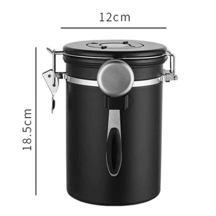 Tall black stainless steel coffee storage jar with airtight seal and scoop, 12 cm × 18.5 cm.