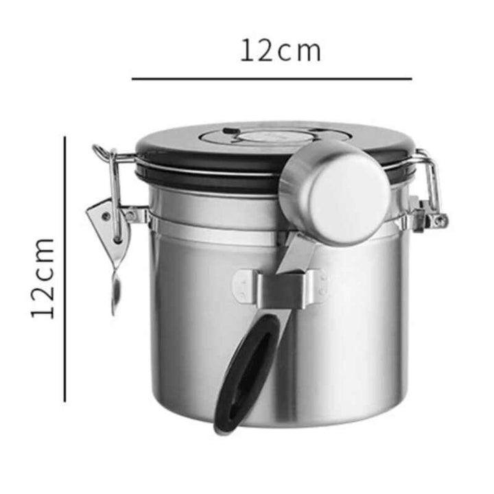 Compact silver stainless steel airtight coffee container with scoop attached, 12 cm × 12 cm.