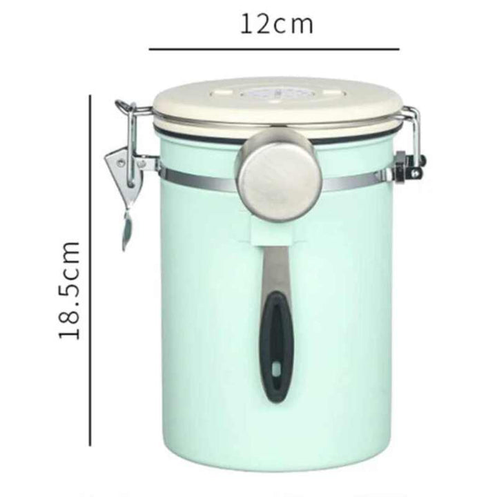 Tall mint green airtight coffee jar with cream lid and steel scoop, 12 cm × 18.5 cm.