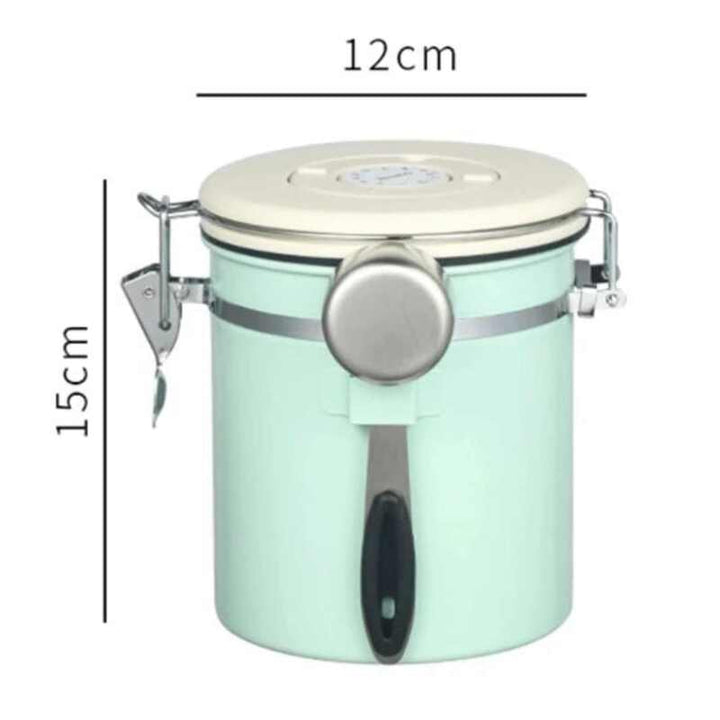 Mint green stainless steel airtight coffee jar with cream lid and metal clasp, 12 cm × 15 cm.