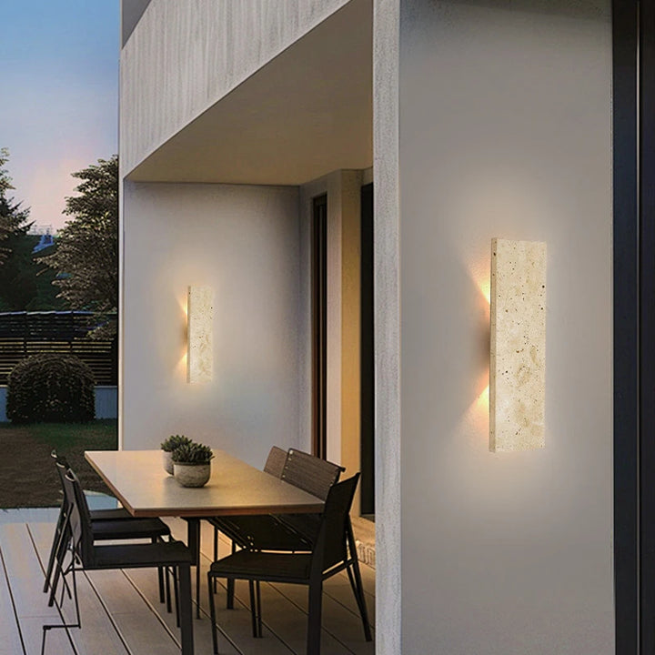 Pair of waterproof natural stone LED wall lamps illuminating outdoor dining patio