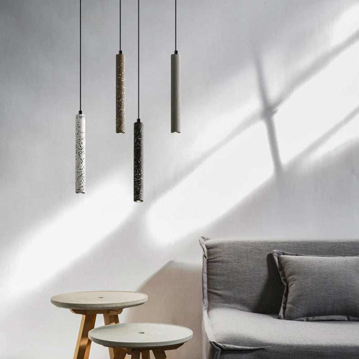 BETON minimalist concrete pendant lamps hanging in living room with grey sofa