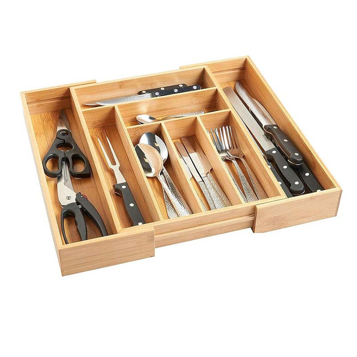 Wooden cutlery organizer with knives, forks, and spoons on a white background