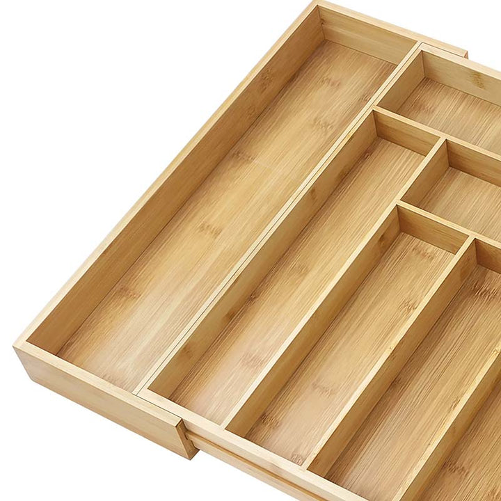 Wooden drawer organizer with compartments on a white background