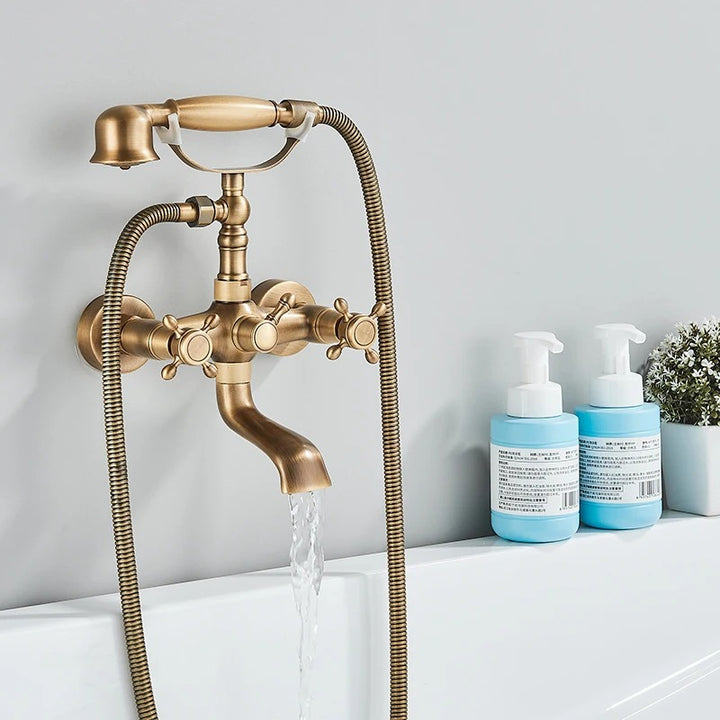 Vintage Brass and Bronze Bathtub Shower Faucet Set for Elegant Bathrooms mounted on the white wall