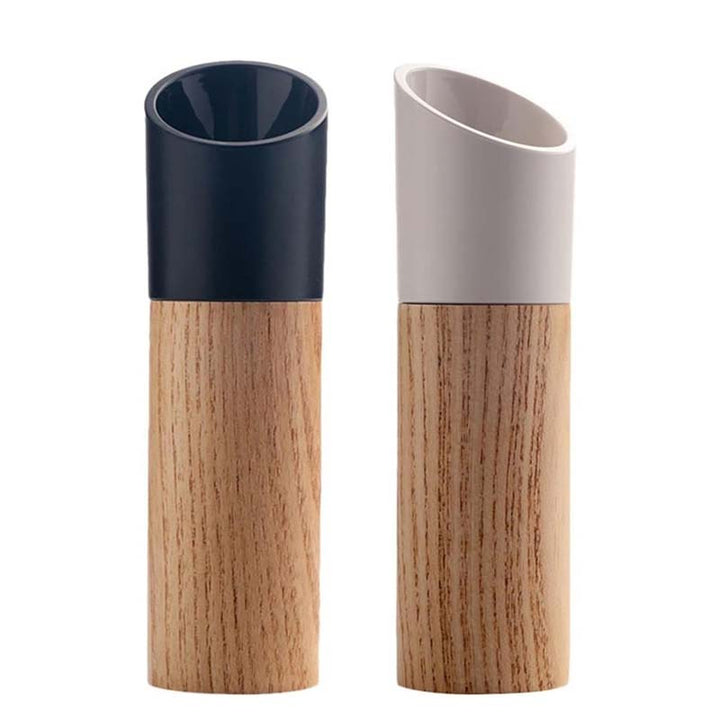 Two cylindrical containers with wooden bases and colored tops on a white background