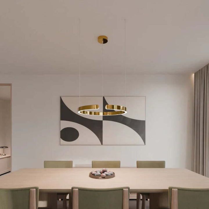 Gold circular LED chandelier over dining table – elegant modern Nordic ceiling light