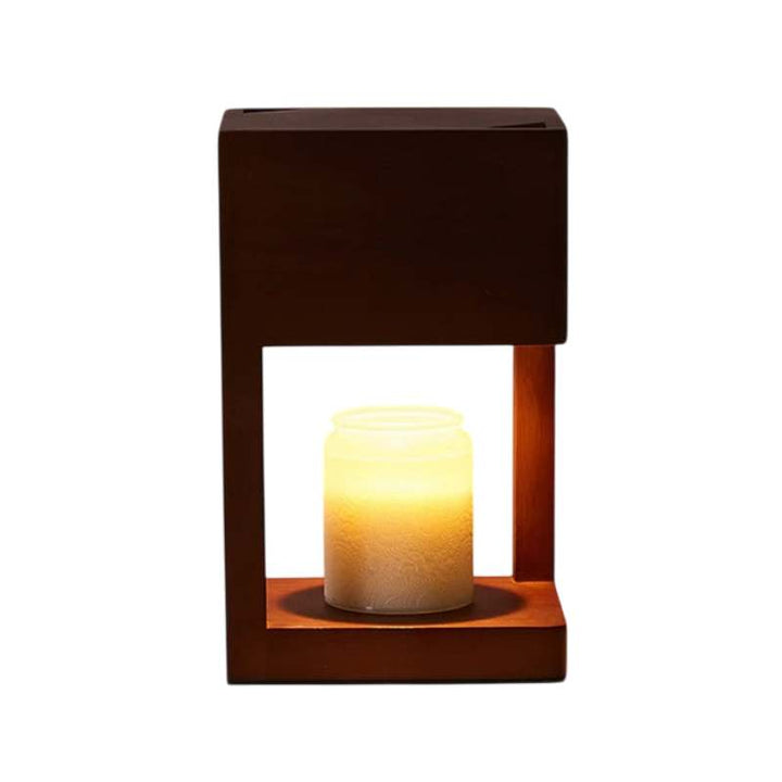 Dark wood candle warmer lamp with open square frame and glowing jar candle