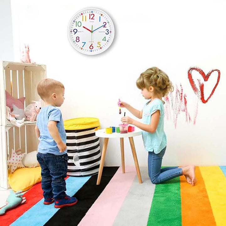 Children playing in a colorful room with a wall clock above them.