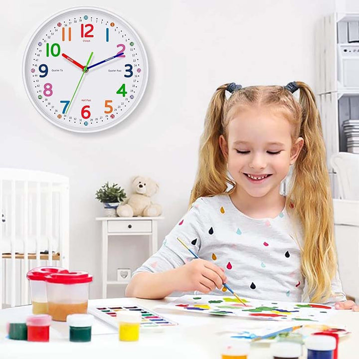 Child painting with a colorful clock on the wall