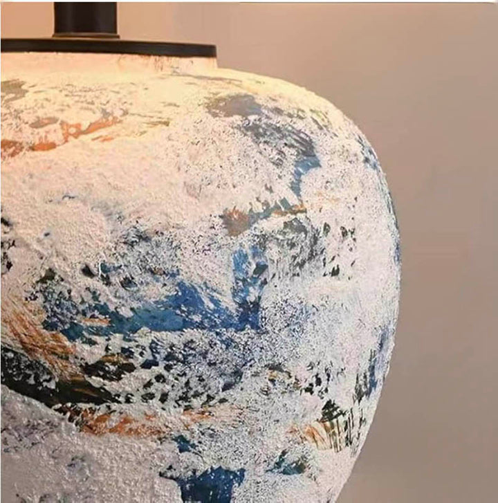 Close-up of HANDLAVET ceramic handcrafted table lamp base, abstract blue/white texture