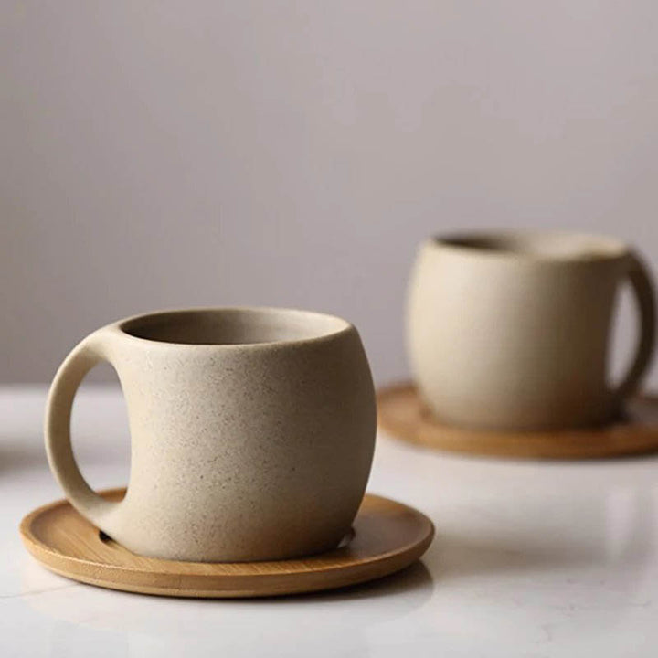 Unglazed porcelain ceramic mug with a smooth matte finish, paired with a natural acacia wood saucer—perfect for coffee, tea, or stylish home cafés.