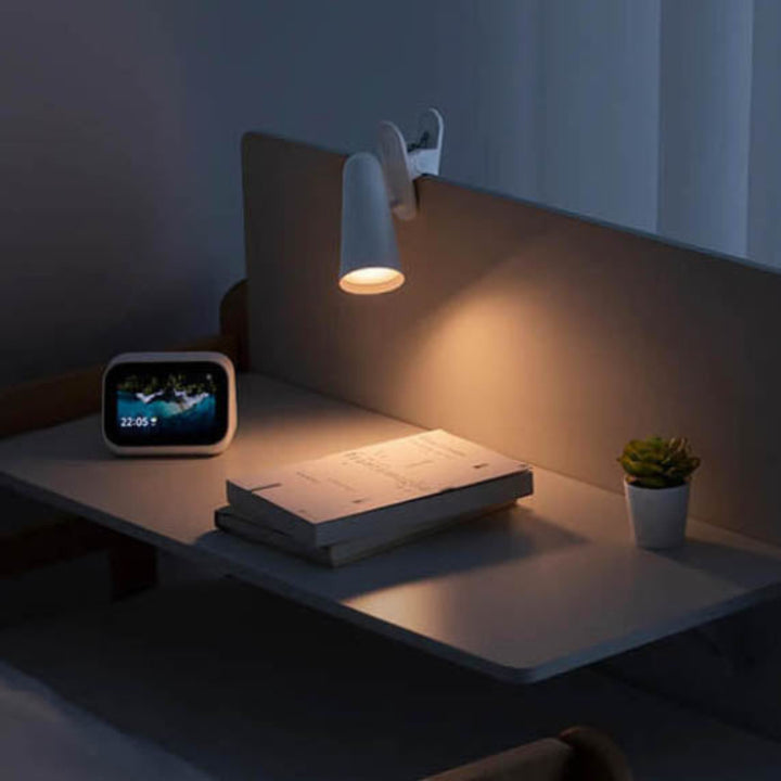 LED reading light clipped onto a wooden headboard, illustrating versatile clip-on feature ideal for bedside reading and minimalist interiors.