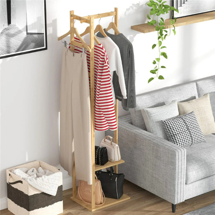 Wooden clothing rack with clothes in a living room setting.