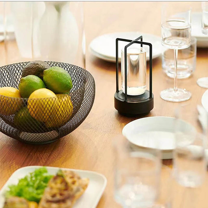 Gold KRYSTAL LED lantern on a dinner table, stylish cordless lighting for modern UK dining setups.