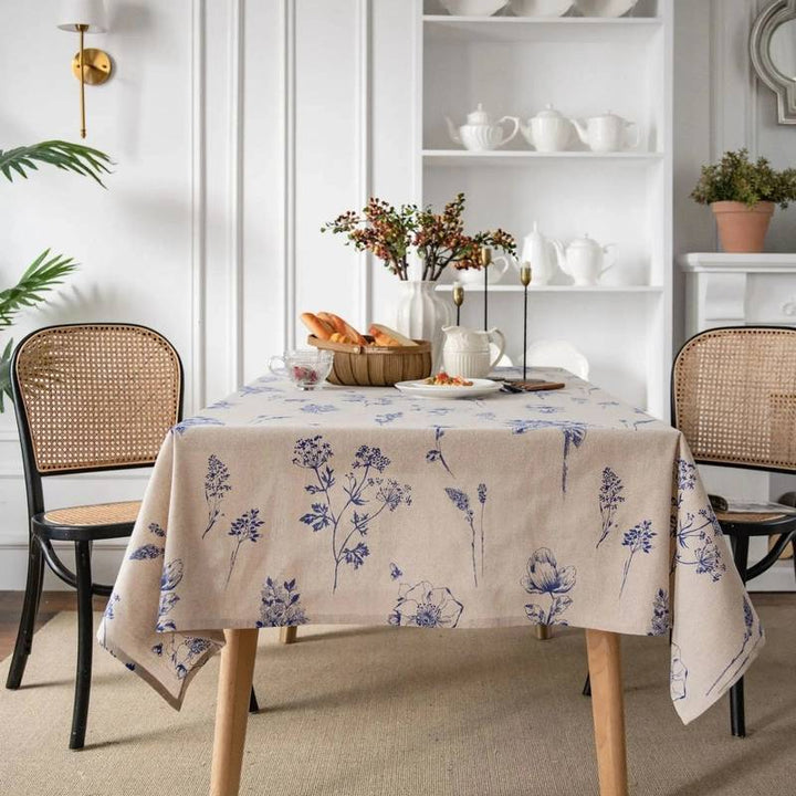 Scandinavian cotton linen tablecloth with blue floral print on dining table, modern minimalist decor.