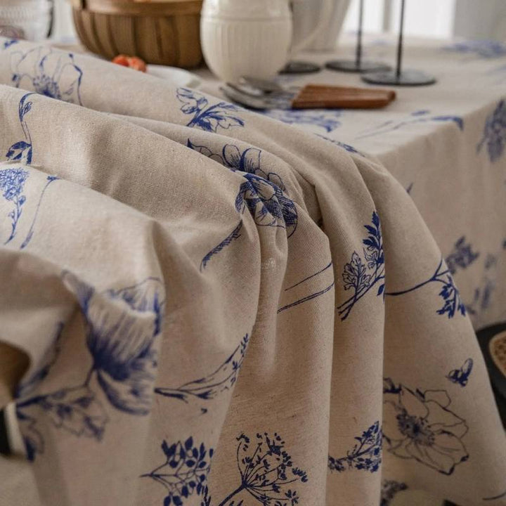 Close-up of Scandinavian cotton linen tablecloth, blue floral pattern, textured fabric for dining.