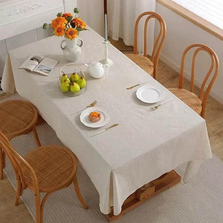 Scandinavian-style beige cotton tablecloth for modern dining room, styled for entertaining guests
