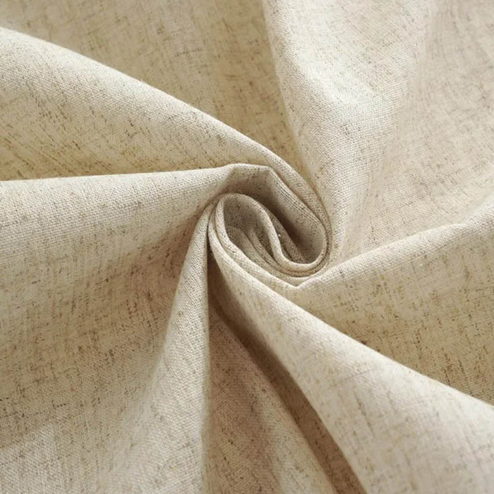 Close-up texture of soft beige 100% cotton fabric, showing breathable weave and quality stitching