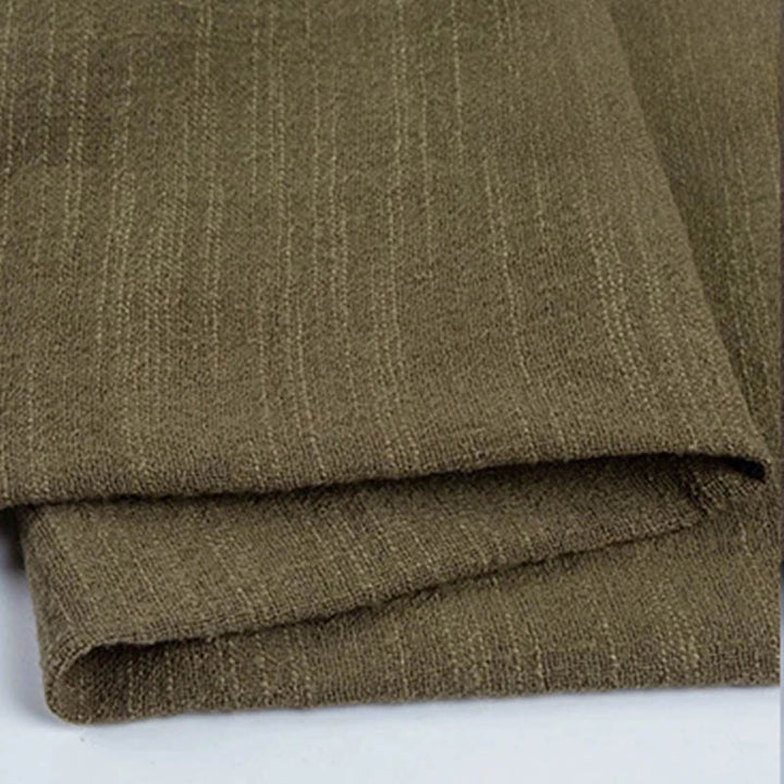 Folded dark green cotton napkin for Weddings and Elegant uk Dining Decor on the white table.