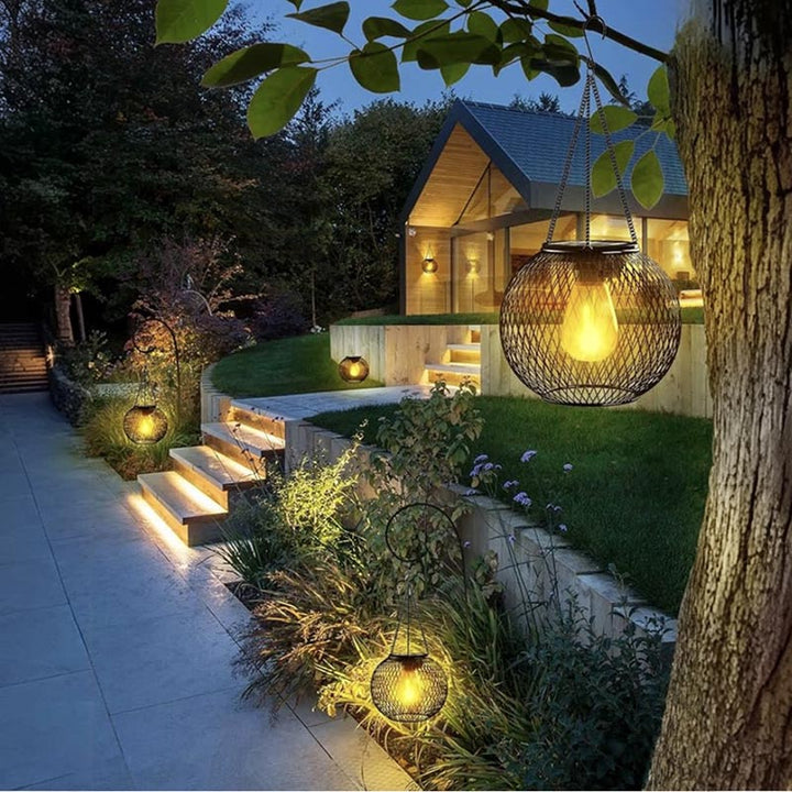 Hanging solar lanterns lighting up a garden pathway with ambient LED glow.