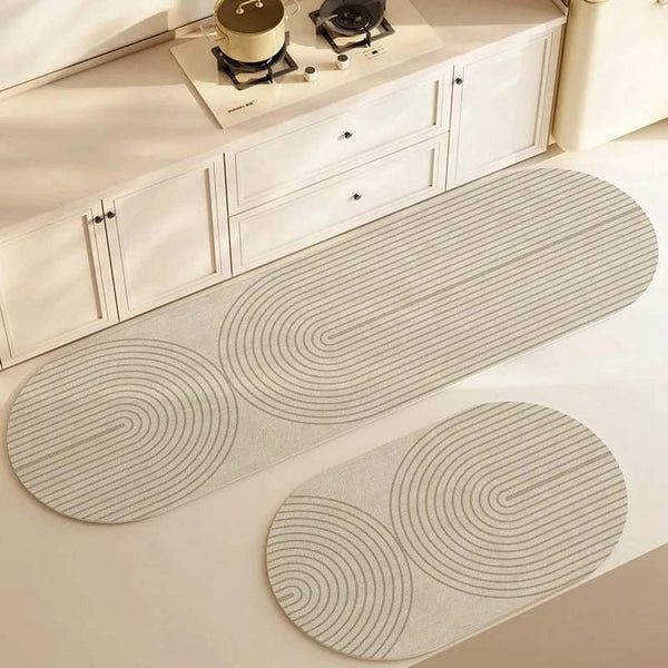 Two oval-shaped kitchen mats on a light-colored floor with white cabinets in the background.