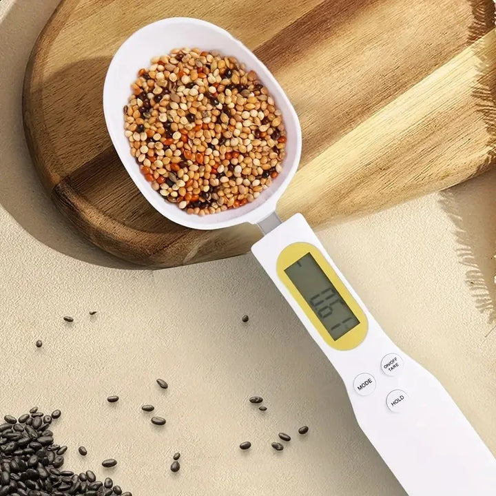 Smart measuring spoon scale with LCD display holding mixed grains on kitchen counter