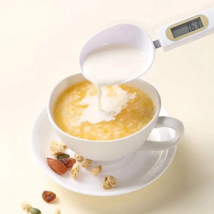 Digital spoon scale pouring milk into cereal bowl with clear LCD display