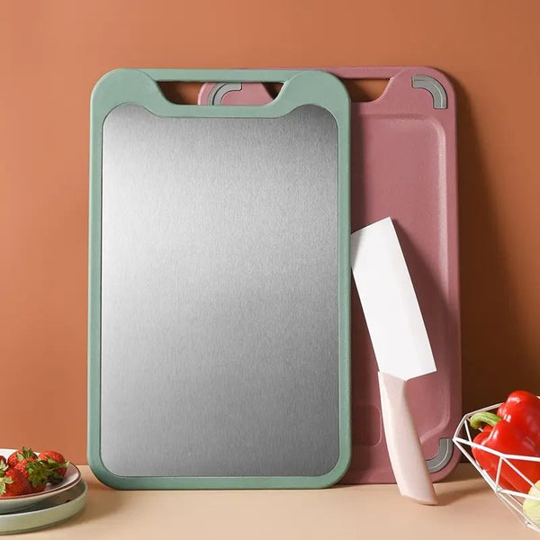 Two cutting boards, one green and one pink, with a knife on a brown background.