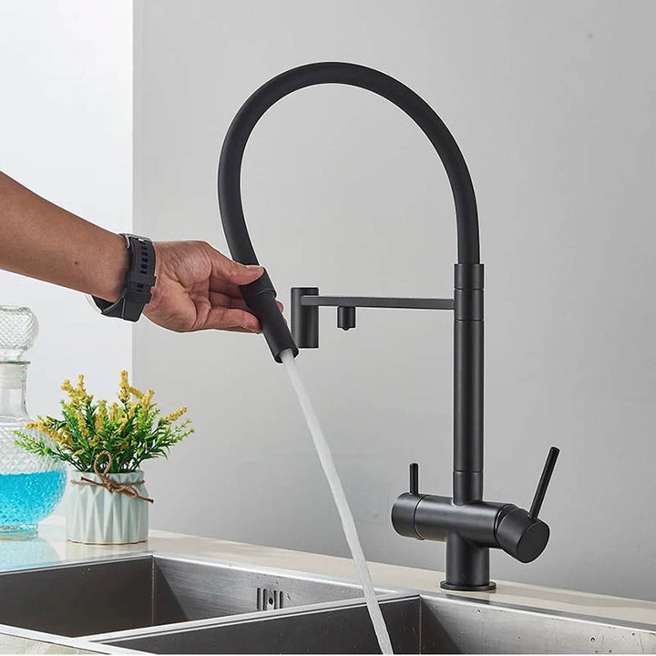 Matte black kitchen mixer tap with flexible pull-out spout in use, ideal for rinsing or filling, shown over dual stainless sink