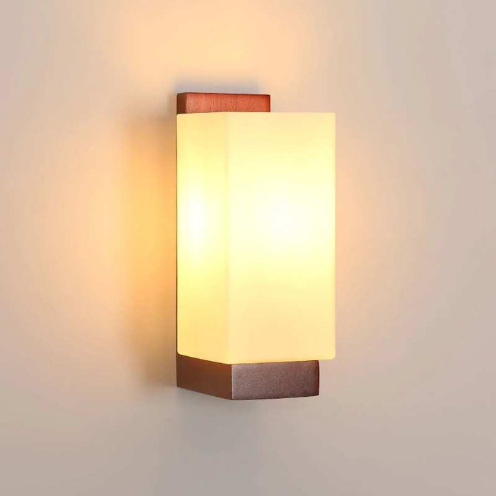 Nordic wood wall light with frosted glass shade emitting warm light, minimalist modern design.