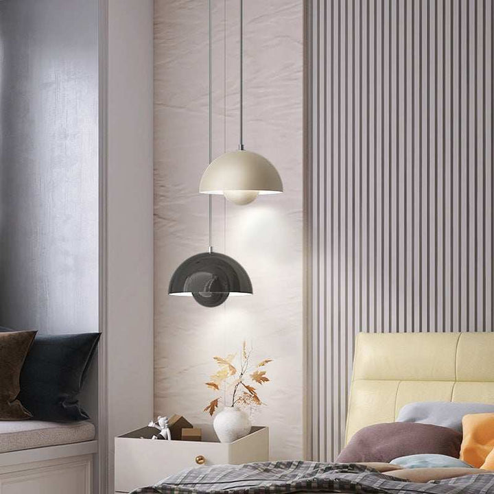 Modern bedroom interior with pendant lights, striped wall, and bed.