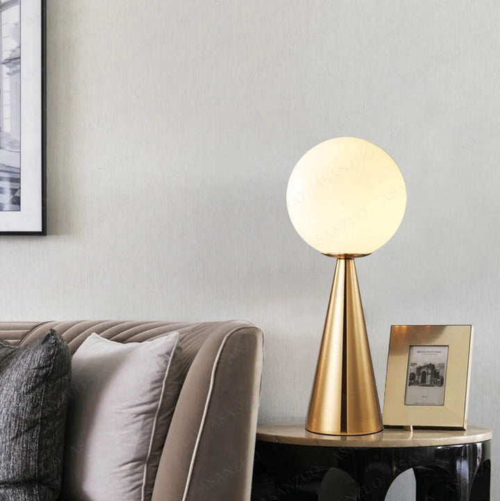 Modern gold cone lamp with glowing globe shade, ideal for elegant bedside or reading nook lighting.