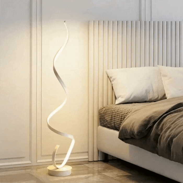 video of the white Modern LED Spiral floor lamp in black aluminium beside sofa, soft warm glow for living room or bedroom