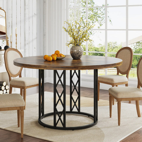 Dining room with a round wooden table and chairs near a large window.