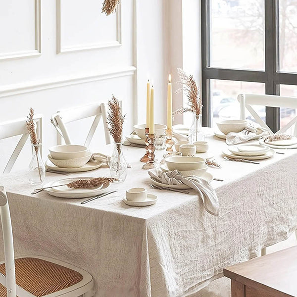 Elegant soft pleated beige tablecloth styled for wedding table with candles and neutral decor