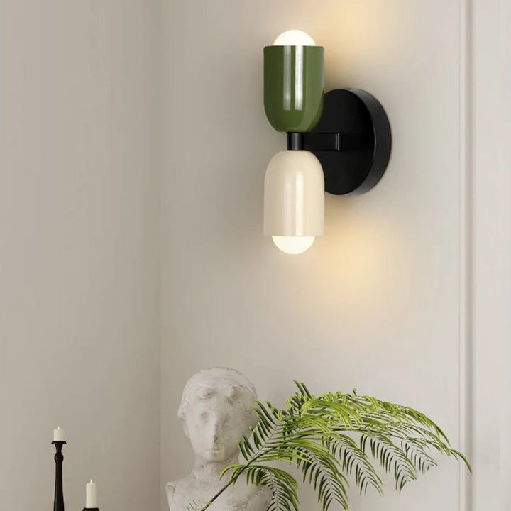 Green and cream FARVERIG LED wall sconce above a plant in Nordic modern interior