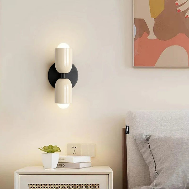 White minimalist LED wall lamp with black backplate in neutral bedroom decor