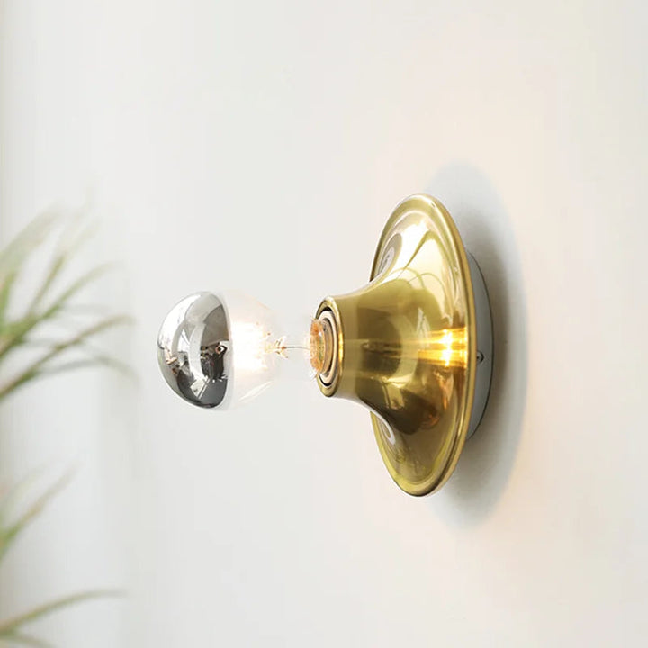 FYR modern wall lamp in brushed brass gold finish with exposed LED bulb Scandinavian design