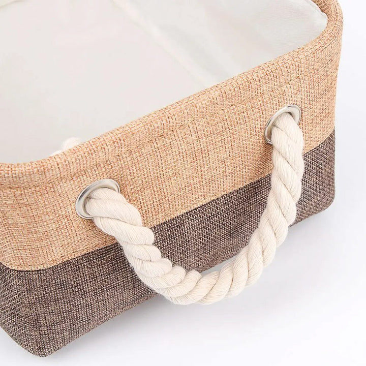 Woven basket with rope handles on a white background